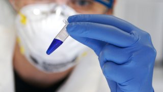 A scientist holds a sample