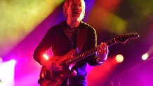 Lead singer of Phish playing a guitar.