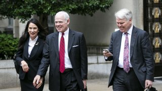In this Oct. 31, 2019, file photo, attorney Charles Chuck Cooper, representing former John Bolton aide Charles Kupperman, center, departs federal court in Washington.