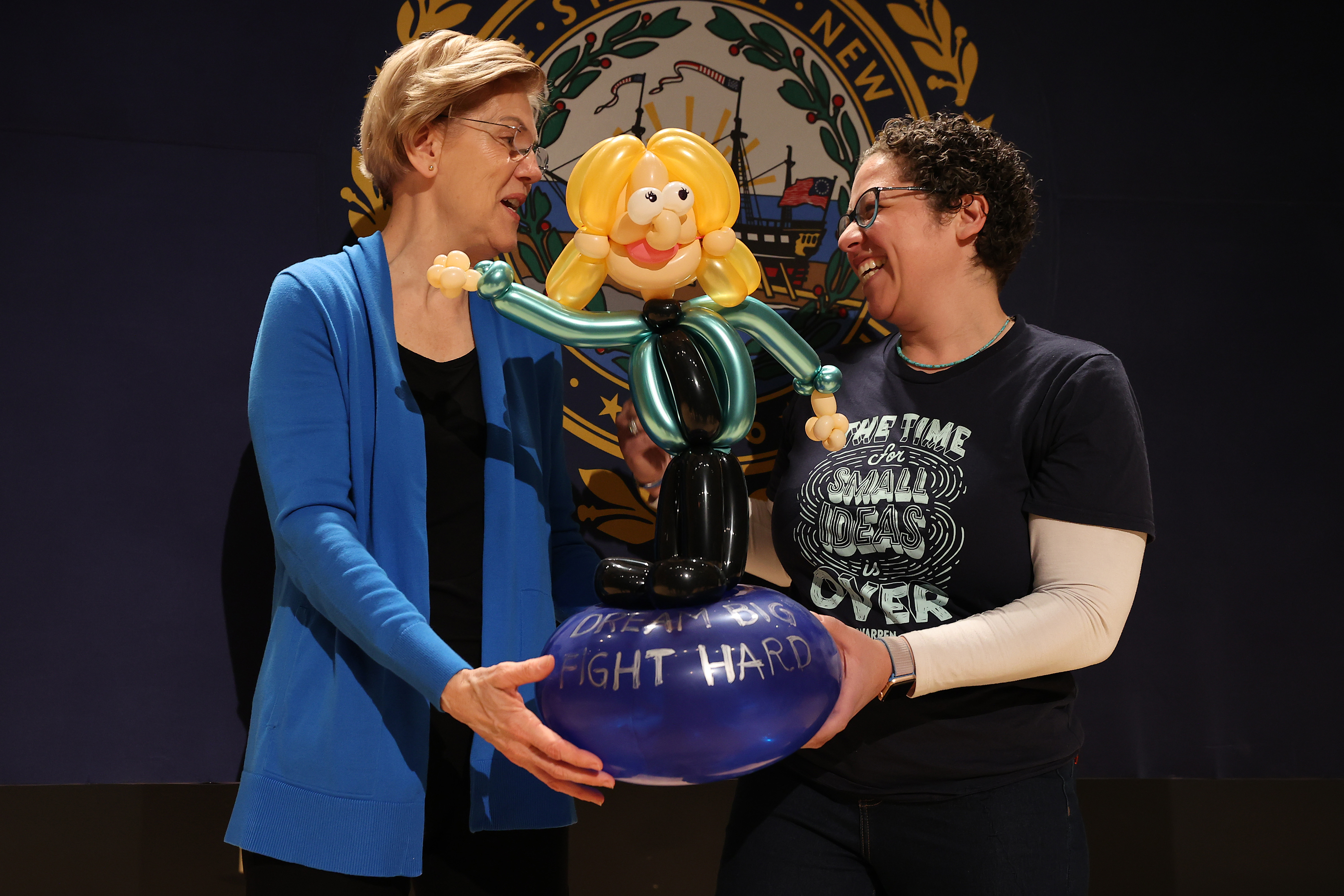 NASHUA, NEW HAMPSHIRE - FEBRUARY 05: Naomi Greenfield of Arlington, Massachusetts, shows Democratic presidential candidate Sen. Elizabeth Warren (D-MA) the balloon sculpture she made of her during a campaign event at Nashua Community College February 05, 2020 in Nashua, New Hampshire. According to a new set of partial Iowa caucus results, Warren is third behind Democratic presidential candidates former South Bend, Indiana Mayor Pete Buttigieg and Sen. Bernie Sanders (I-VT) and ahead of former Vice President Joe Biden. (Photo by Chip Somodevilla/Getty Images)