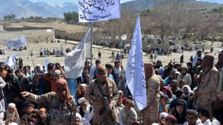 Afghan Taliban militants and villagers attend a gathering as they celebrate the peace deal and their victory in the Afghan conflict on US in Afghanistan, in Alingar district of Laghman Province on March 2, 2020. - The Taliban said on March 2 they were resuming offensive operations against Afghan security forces, ending the partial truce that preceded the signing of a deal between the insurgents and Washington.