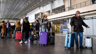 People gather at Moscow's Sheremetyevo airport terminal F