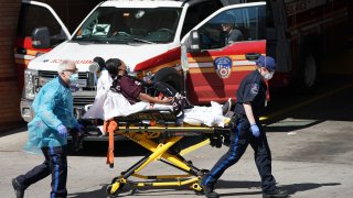 EMTs bring a patient into Wyckoff Hospital in Brooklyn on April 6, 2020.