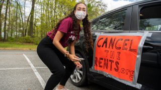 A demonstrator prepares for a national day of car protest to cancel the rents drive through Washington, D.C., to call for the cancellation of rents, mortgages and related utility bills, for the duration of the COVID-19 crisis in Rock Creek Park on Saturday, April 25, 2020.