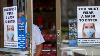 GLENDALE, CA – MAY 27: A man exits a Shoe City store where masks are required for entry as Los Angeles County retail businesses reopen while the COVID-19 pandemic continues on May 27, 2020 in Glendale, Californias latest guidelines and allow the resumption of in-store shopping at low-risk retail stores, faith-based services, drive-in theaters and other recreational activities with reduced capacities and social distancing restrictions, starting today. Not reopening yet are personal services locations like hair salons and dining in at restaurants. (Photo by David McNew/Getty Images)