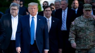 U.S. President Donald Trump walks with US Attorney General William Barr (L), US Secretary of Defense Mark T. Esper (C), Chairman of the Joint Chiefs of Staff Mark A. Milley (R), and others from the White House to visit St. John's Church after the area was cleared of people protesting the death of George Floyd June 1, 2020, in Washington, D.C.