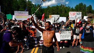 Activists and members of different tribes from the region block the road to Mount Rushmore National Monument