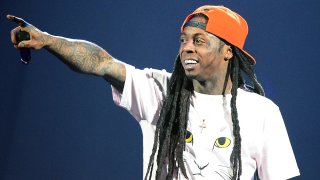 In this Aug. 21, 2013, file photo, rapper Lil Wayne performs during the America's Most Wanted Music Festival at the MGM Grand Garden Arena in Las Vegas, Nevada.