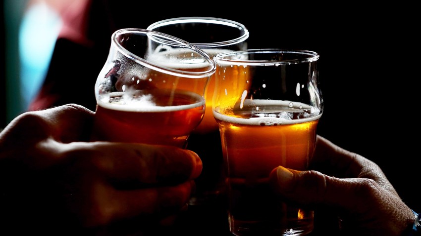 In this Feb. 7, 2014, file photo, Russian River Brewing Company customers clink their glasses while drinking the newly released Pliny the Younger triple IPA beer in Santa Rosa, California.