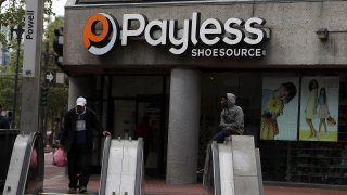 In this April 5, 2017, file photo, a pedestrian walks by a Payless Shoe Source store in San Francisco, California.