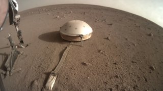 This Feb. 18, 2020 photo made available by NASA shows the InSight lander's dome-covered seismometer, known as SEIS, on Mars.