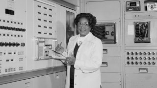 In this 1977 file photo, mathematician Mary Jackson, the first black woman engineer at NASA, poses for a photo at work at NASA Langley Research Center in Hampton, Virginia.