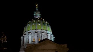 The Pennsylvania State Capitol dome rises in the night sky
