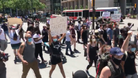 Demonstrators walk outside Philadelphia City Hall on May 30,2020 as part of a demonstration against police violence following the death of George Floyd.