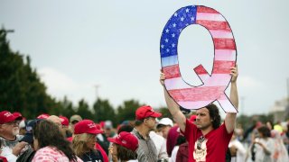 David Reinert holding a Q sign waits in line with others to enter a campaign rally with President Donald Trump Republican U.S. Senate candidate Rep. Lou Barletta, R-Pa., Thursday, August 2, 2018 in Wilkes-Barre, Pa.