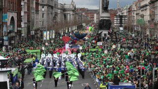 Thousands of people line the streets of O’Connell Street to watch the St Patrick’s day parade in Dublin, Ireland, Monday March, 17, 2014.