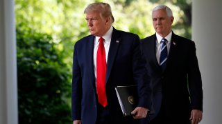 President Donald Trump and Vice President Mike Pence arrive to a news conference in the Rose Garden of the White House in Washington, D.C., April 27, 2020.