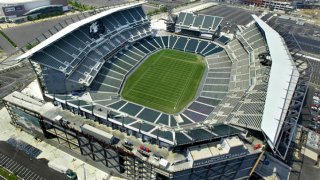 An aerial view of Lincoln Financial Field shows the field surrounded by thousands of empty seats.