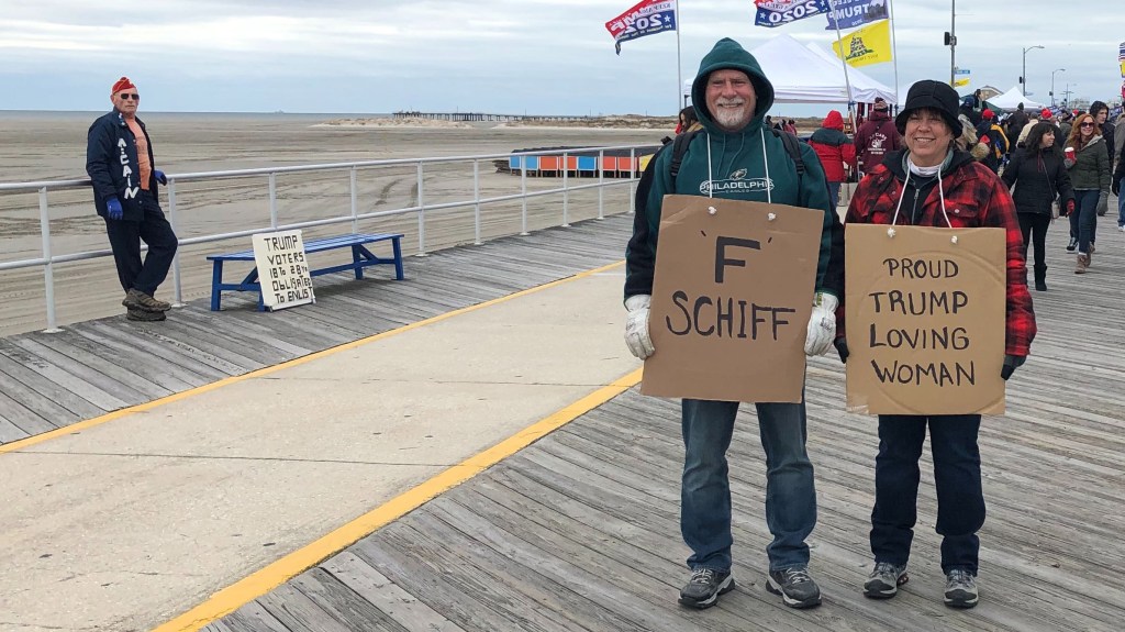 Man and woman stand on boardwalk