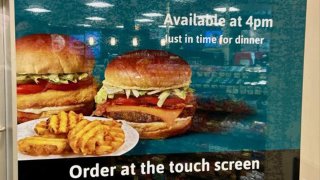 A sign shows burgers and waffle fries from Wawa.