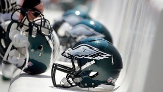 Philadelphia Eagles helmets on a bench