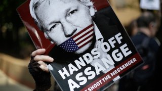 In this May 1, 2019, file photo, protesters demonstrate outside court where Julian Assange will appear in London.