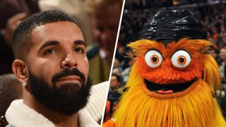 The artist Drake (left) and Gritty (right), the official mascot for the Philadelphia Flyers National Hockey League team.