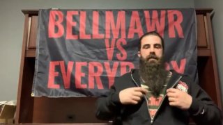 Man sitting in front of flag reading "Bellmawr versus Everybody"