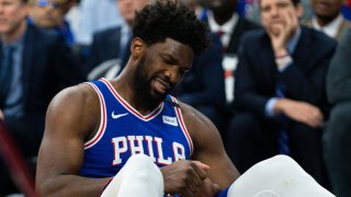 Philadelphia 76ers center Joel Embiid (21) reacts after falling on his injured hand during the third quarter against the Oklahoma City Thunder at Wells Fargo Center.
