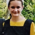 smiling girl in apron and dress