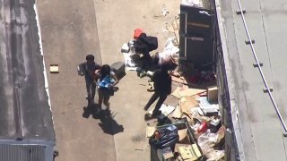 People carry merchandise as they loot a store in Philadelphia's Port Richmond neighborhood.