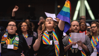 Shelby Ruch-Teegarden, center, of Garrett-Evangelical Theological Seminary joins other protestors during the United Methodist Church's special session of the general conference in St. Louis, Tuesday, Feb. 26, 2019.