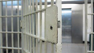 A jail cell door opens