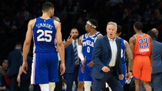 Philadelphia 76ers head coach Brett Brown reacts in front of guard Ben Simmons