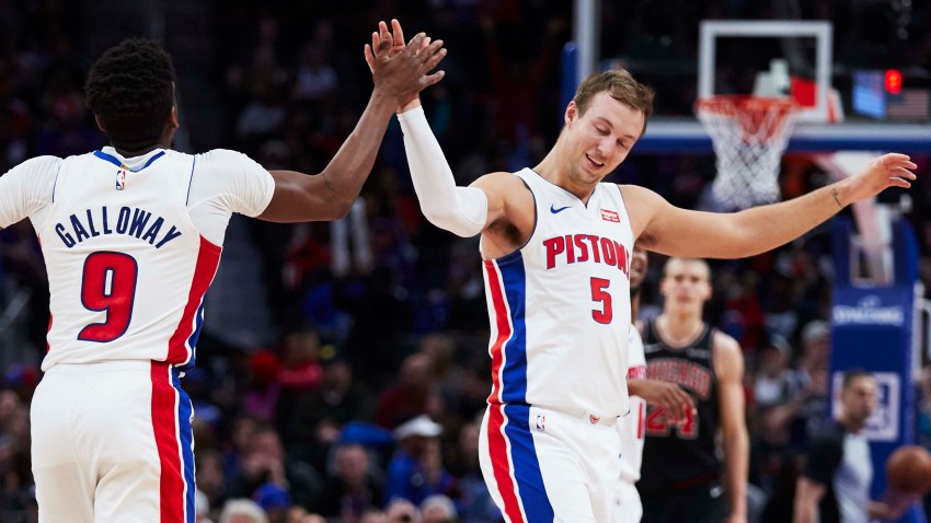 Detroit Pistons guard Langston Galloway (9) receives congratulations from guard Luke Kennard (5) after he makes a three point basket