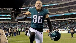 Zach Ertz of the Philadelphia Eagles takes of his helmet and celebrates.