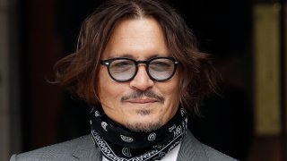 In this July, 13, 2020, file photo, American actor Johnny Depp poses for the media as he arrives at the High Court in London.