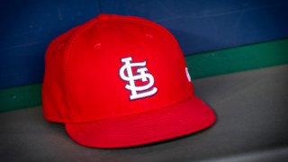 In this file photo, a St. Louis Cardinals hat sits in the dugout during the MLB interleague game against the Kansas City Royals on August 11, 2018 at Kauffman Stadium in Kansas City, Missouri.