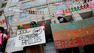 Demonstrators protest outside the Immigration and Customs Enforcement (ICE) headquarters