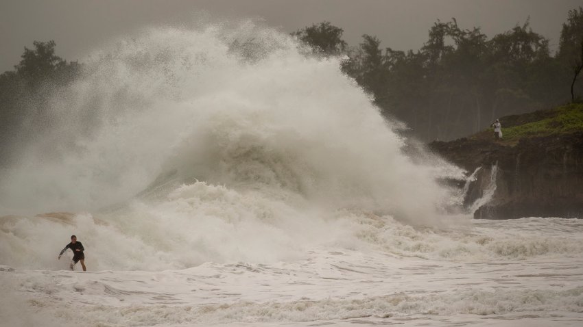 A surfer takes on a wave generated by Hurricane Douglas at Laie Beach Park, Sunday, July 26, 2020, in Laie, Hawaii.