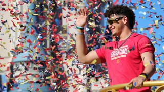 Under a shower of confetti, Kansas City Chiefs quarterback Patrick Mahomes waves to cheering fans during a parade in the team's honor at the Magic Kingdom at Walt Disney World, in Lake Buena Vista, Fla., Feb. 2, 2020.