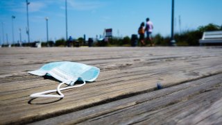 A mask lies on the boardwalk