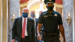 Postmaster General Louis DeJoy, left, is escorted to House Speaker Nancy Pelosi's office on Capitol Hill in Washington, Wednesday, Aug. 5, 2020.