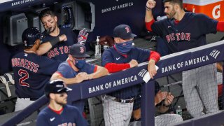 Boston Red Sox's Xander Bogaerts (2) celebrates with teammates in the dugout after hitting a fifth-inning solo home run in a baseball game against the New York Yankees, Sunday, Aug. 2, 2020, at Yankee Stadium in New York.