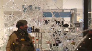 A broken window at Nordstrom Rack is seen during unrest near 7th St. S. and Nicollet Mall in Minneapolis on Aug. 26, 2020.