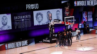 The Sacramento Kings take the court against the New Orleans Pelicans prior to the start of the game of an NBA basketball game Tuesday, Aug. 11, 2020, in Lake Buena Vista, Fla.