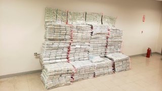 This photo provided by the Drug Enforcement Administration Caribbean Division Office shows what it reports is 27 million dollars seized on Aug. 29 as part of the Inter-agency operation, at the US Customs and Border Protection, CBP, headquarters in San Juan, Puerto Rico, Monday, Aug. 31, 2020. CBP says the undeclared currency was found inside boxes bound to St. Thomas, US Virgin Islands.