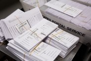 Sample voting ballots sit in a pile during a training on a new ballot sorting machine at the Board of Elections in Doylestown, Pennsylvania