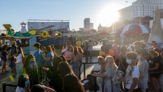 People wearing masks avoid social distancing while waiting in line at the Steel Pier as the state of New Jersey continues Stage 2 of re-opening following restrictions imposed to slow the spread of coronavirus on September 05, 2020 in Atlantic City, New Jersey.