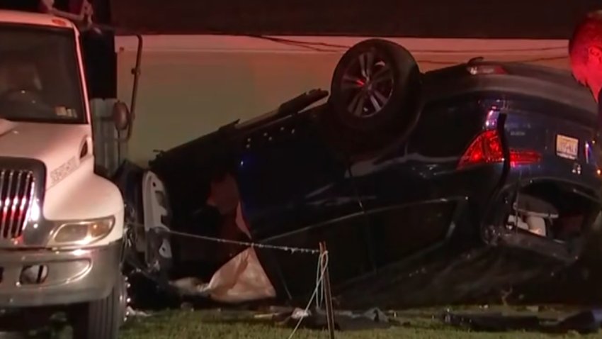 A blue SUV rests on its roof after a crash in Bucks County.